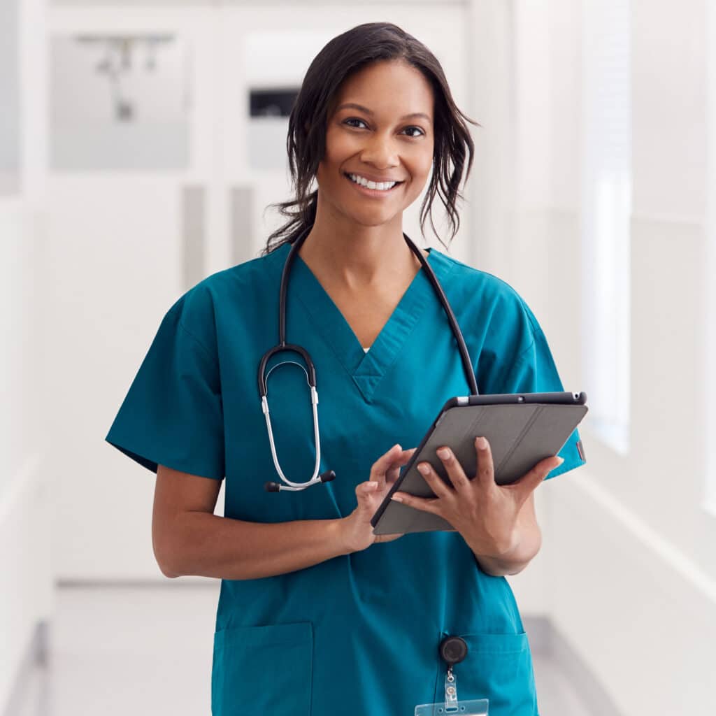 Wearing Scrubs In Hospital Corridor