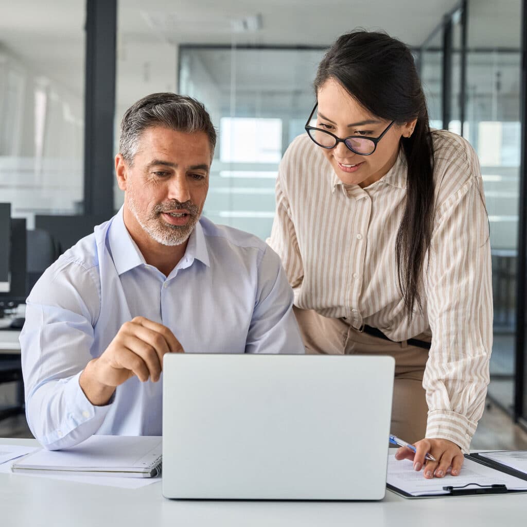 Professional coworkers discussing online plan at work