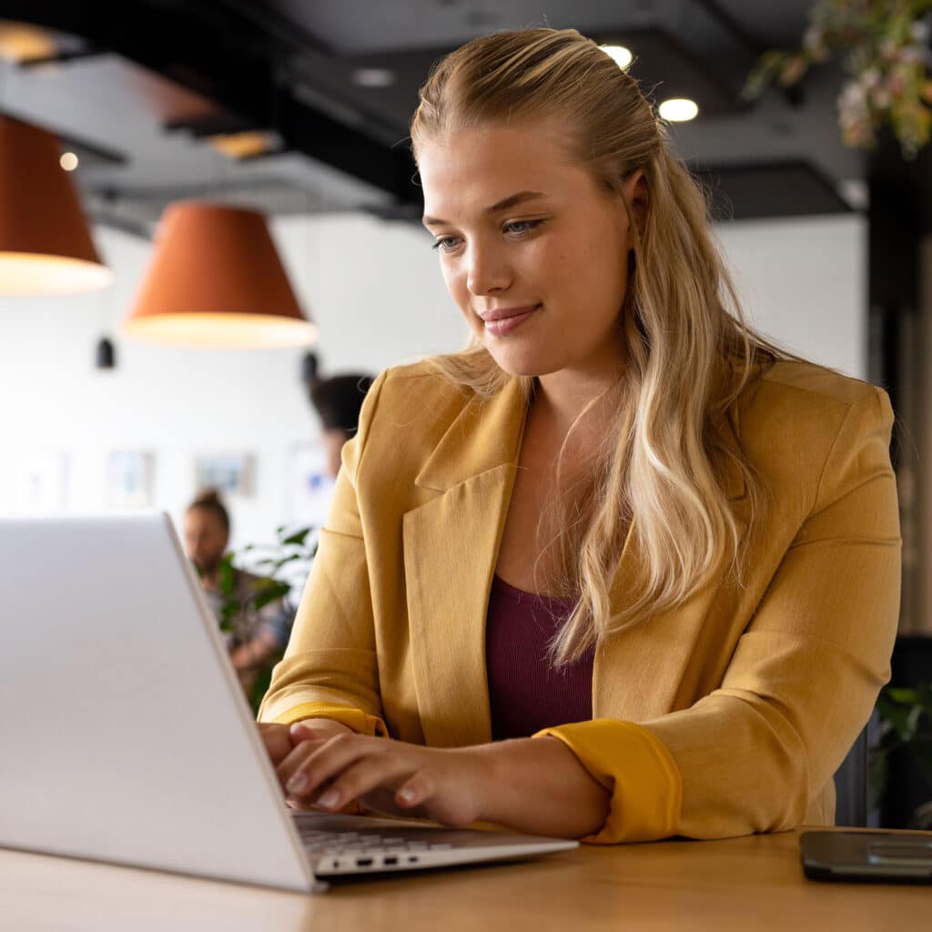 Professional woman using laptop at desk
